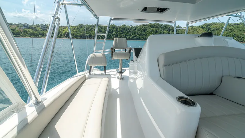 Slide: The Image of Flybridge Seating Area The flybridge of the 2024 Viking 64 Convertible offers a luxurious seating area with plush, wraparound cushions. The space is designed for comfort and functionality, featuring a helm chair with unobstructed views. Stainless steel accents and panoramic win - 7162601