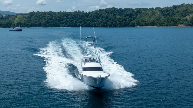 Slide: The Image of Viking 64 Convertible Bow View This dynamic image captures the Viking 64 Convertible in motion, showcasing its sleek bow cutting through the water with precision. The vessel's powerful performance is highlighted by the impressive wake trailing behind, emphasizing its capability and spe - 7162618