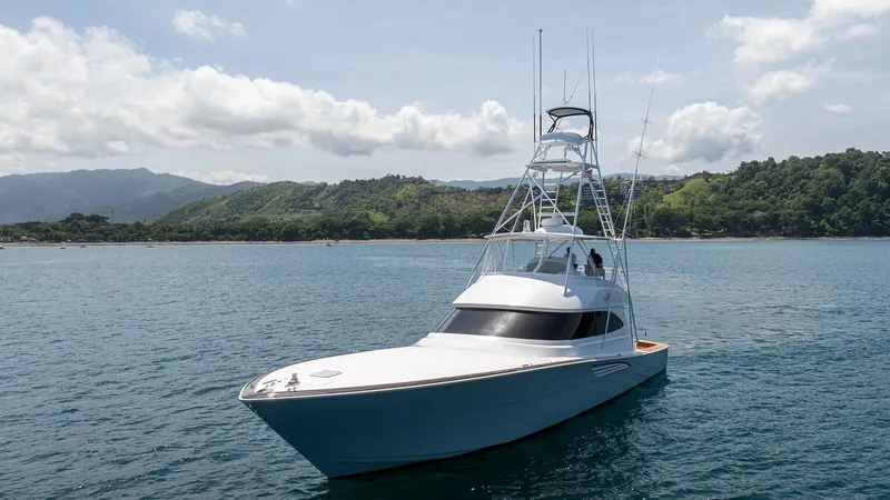 Slide: The Image of Viking 64 Convertible Bow View The Viking 64 Convertible showcases a sleek bow design, emphasizing its powerful presence on the water. The expansive foredeck provides an unobstructed view, perfect for navigating the open seas. Its towering tuna tower is a notable feature, ideal for spo - 7162610