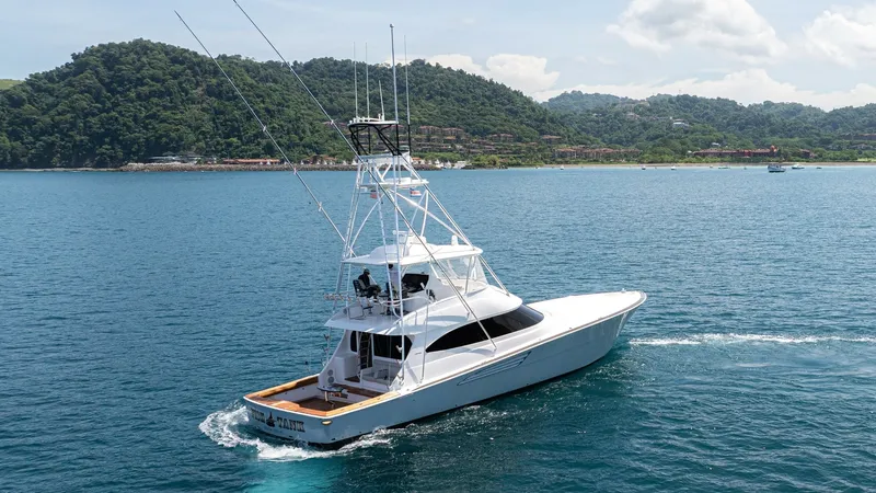 Slide: The Image of Aerial View of Viking 64 Convertible This stunning aerial shot showcases the sleek design of the 2024 Viking 64 Convertible. The vessel glides effortlessly through the water, highlighting its robust build and spacious aft deck, perfect for fishing or entertaining. The towering tuna tower enh - 7162615