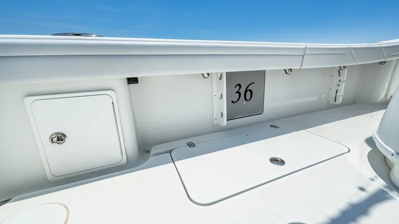 Slide: The Image of Cockpit Storage Area and Deck The image showcases the spacious cockpit storage area on the 2021 Yellowfin 36 Offshore. Featuring secure compartments and a clean, non-slip deck, this area is designed for practicality and ease of use during offshore adventures. The sleek finish and dura - 7150885