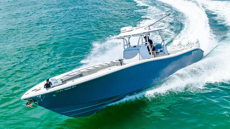 Slide: The Image of Dynamic Bow View in Motion The 2021 Yellowfin 36 Offshore cuts through the water with precision, showcasing its sleek hull and impressive design. The vessel's sharp bow and commanding stance highlight its capability for high-speed offshore adventures. With its open layout and robus - 7150923