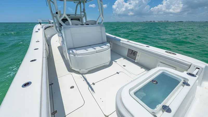 Slide: The Image of Spacious Aft Deck with Seating The 2021 Yellowfin 36 Offshore showcases a spacious aft deck, designed for both comfort and functionality. The seating area provides ample space for relaxation, while the clean, non-slip deck ensures safety even in rough waters. The sleek design and high- - 7150881
