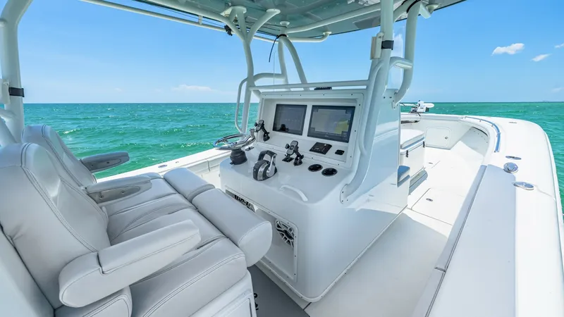 Slide: The Image of Helm Station with Seating The helm station of the 2021 Yellowfin 36 Offshore features dual high-back captain's chairs with plush cushioning, ensuring comfort during long voyages. The dash is equipped with state-of-the-art navigation and communication systems, housed within a sleek - 7150889