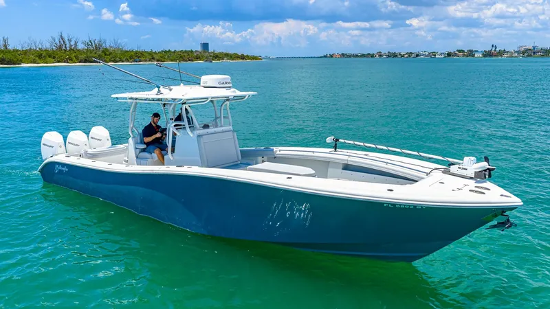 Slide: The Image of Side Profile of 36 Offshore Model This image showcases the sleek and robust side profile of the 2021 Yellowfin 36 Offshore. The boat is equipped with triple outboard engines, ensuring powerful performance on the water. The spacious deck layout is designed for both fishing and leisure, fea - 7150873
