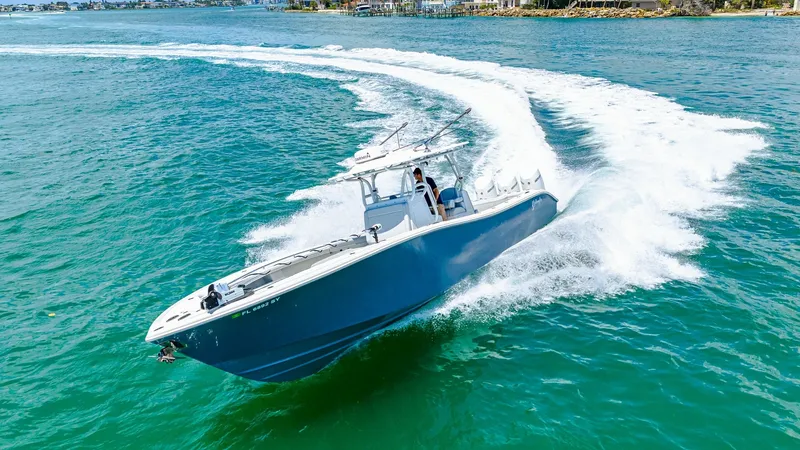 Slide: The Image of Aerial View of 36 Offshore Cruising The 2021 Yellowfin 36 Offshore cuts through the water with precision, showcasing its sleek hull and powerful performance. The spacious deck is designed for both serious fishing and leisure, offering ample room for movement and activity. Its aerodynamic de - 7150922