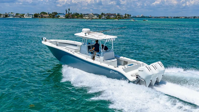 Slide: The Image of Aerial View of Yellowfin 36 Offshore This aerial shot captures the sleek and powerful design of the 2021 Yellowfin 36 Offshore, cutting through the water with precision. The image highlights the triple outboard engines, providing exceptional performance and speed. With its spacious deck and - 7150929