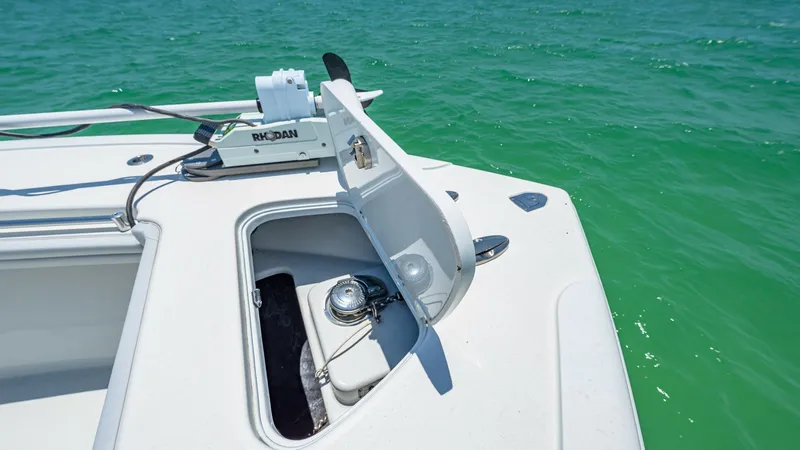 Slide: The Image of Bow Anchor Locker and Windlass This image showcases the bow area of the 2021 Yellowfin 36 Offshore, featuring an open anchor locker with a robust windlass system. The clean, spacious deck is designed for easy access and efficient handling. The clear blue ocean provides a stunning backd - 7150907