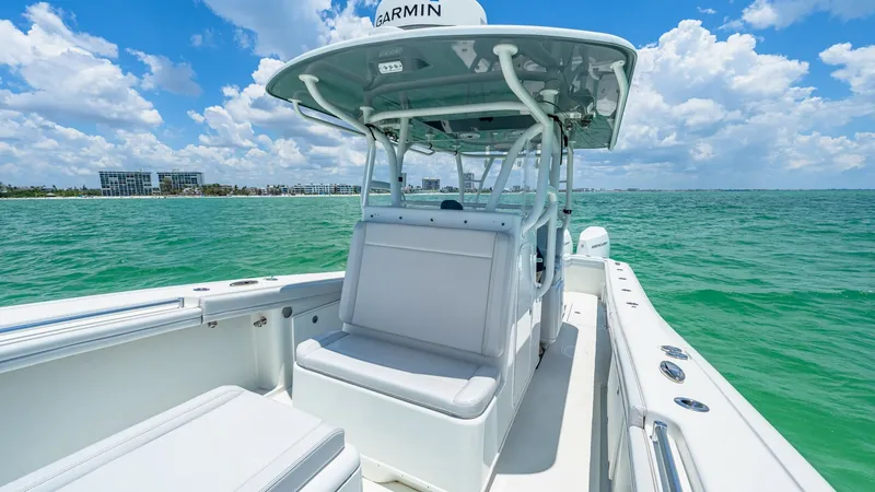 Slide: The Image of Center Console Helm Seating Area This image showcases the sleek center console of the 2021 Yellowfin 36 Offshore, featuring comfortable helm seating with a robust T-top for protection against the elements. The spacious deck provides ample room for maneuvering, while the ergonomic layout - 7150910