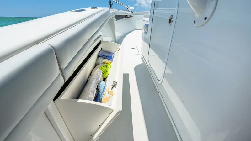 Slide: The Image of Starboard Side Deck Storage Compartment This image showcases the starboard side deck of the 2021 Yellowfin 36 Offshore, featuring a convenient storage compartment. The compartment is neatly integrated into the bulwark, providing easy access to essential items while maintaining a sleek profile. - 7150901