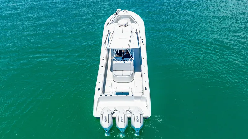 Slide: The Image of Aerial View of Triple Outboard Setup This 2021 Yellowfin 36 Offshore showcases a powerful triple outboard configuration, designed for high performance and speed on the water. The spacious deck layout is optimized for fishing, with ample room for maneuverability. The sleek design and robust b - 7150871