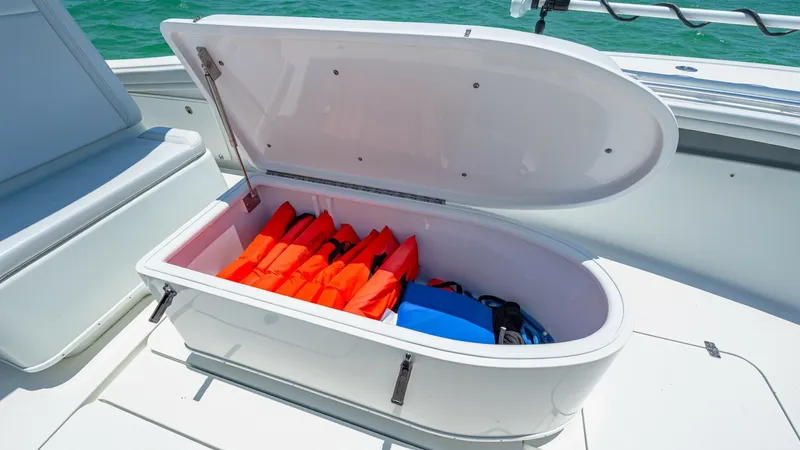 Slide: The Image of Spacious Deck Storage Compartment This image showcases the ample storage compartment on the 2021 Yellowfin 36 Offshore, perfect for stowing life jackets and gear. The compartment is designed with a sleek, easy-to-lift lid and sturdy construction, ensuring durability and ease of access. It - 7150912