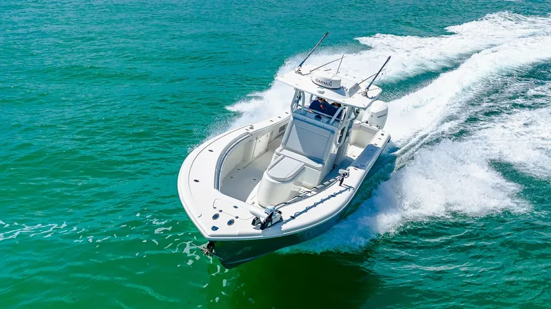 Slide: The Image of Aerial View of Bow in Motion This image showcases the dynamic bow of the 2021 Yellowfin 36 Offshore, gracefully cutting through the vibrant blue waters. The sleek design and spacious deck provide exceptional visibility and maneuverability, ideal for offshore adventures. The robust co - 7150926
