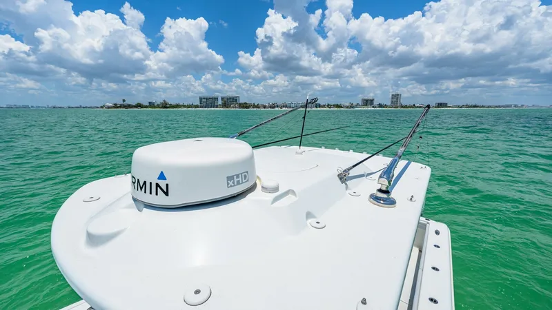 Slide: The Image of Bow with Garmin Radar System The bow of the 2021 Yellowfin 36 Offshore is equipped with a state-of-the-art Garmin radar system, ideal for navigation and safety. The sleek, white deck contrasts against the vibrant blue waters, offering a smooth and modern aesthetic. This advanced setu - 7150911