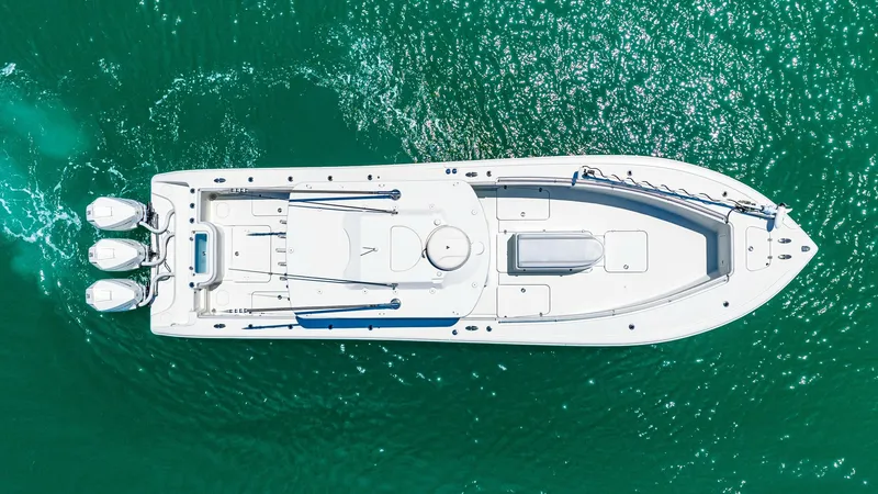 Slide: The Image of Aerial View of 36 Offshore Deck This aerial shot showcases the expansive deck layout of the 2021 Yellowfin 36 Offshore. Featuring a streamlined design with a spacious bow and ample seating, the vessel is ideal for both leisure cruising and serious fishing. The triple outboard engines at - 7150870