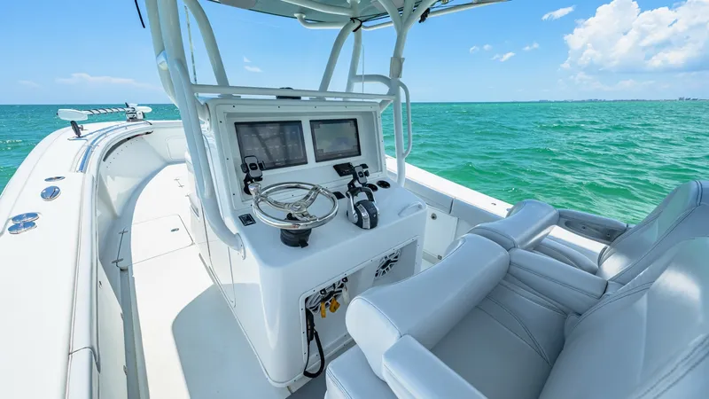 Slide: The Image of Helm Station with Dual Seating The helm station of the 2021 Yellowfin 36 Offshore features a modern console with dual multifunction displays and a sleek steering wheel. Dual cushioned seats provide comfort and support for long journeys, while the open view offers excellent visibility f - 7150864