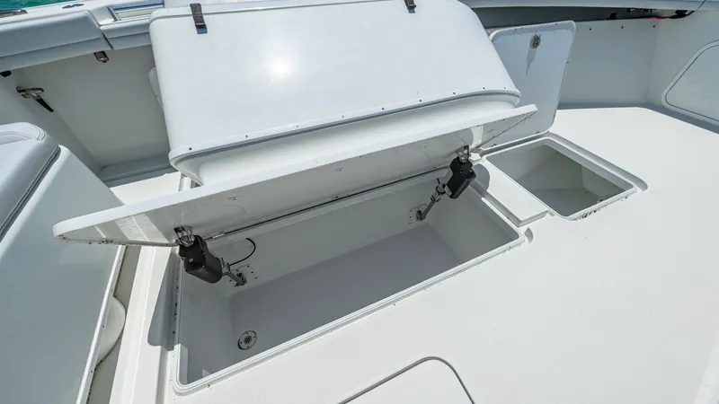Slide: The Image of Bow Storage Compartment Open View This image showcases the spacious bow storage compartment of the 2021 Yellowfin 36 Offshore. The compartment is designed for easy access and ample storage, with sturdy hydraulic supports for smooth operation. The clean, white finish and robust constructio - 7150913