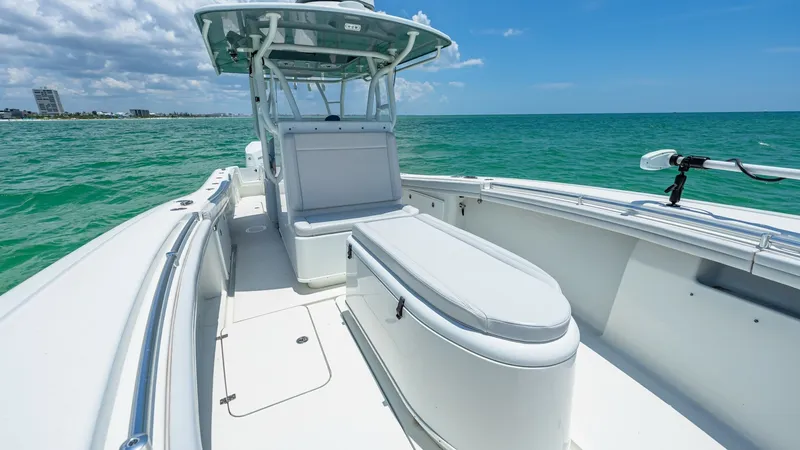 Slide: The Image of Spacious Forward Deck and Console The 2021 Yellowfin 36 Offshore showcases a sleek forward deck, ideal for fishing or relaxation. Featuring a comfortable console seat with ample storage beneath, this area combines functionality with comfort. The open deck space offers unobstructed views, - 7150909