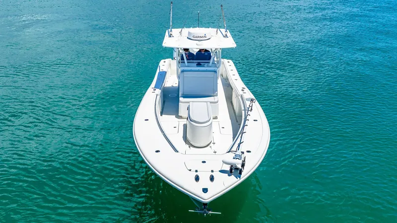 Slide: The Image of Aerial View of Bow and Deck This aerial shot captures the sleek design of the 2021 Yellowfin 36 Offshore's bow and deck. The spacious layout is ideal for fishing or leisure, featuring a robust center console and ample seating. The pristine white finish complements the vessel's moder - 7150869