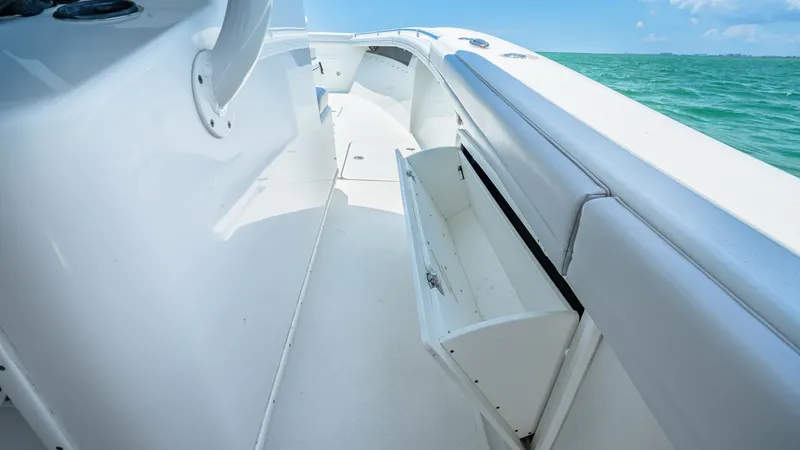 Slide: The Image of Starboard Passageway with Storage Compartment This image showcases the sleek starboard passageway of the 2021 Yellowfin 36 Offshore. The clean lines and spacious walkway provide ease of movement, while the integrated storage compartment offers practicality for stowing away gear. The pristine white su - 7150902