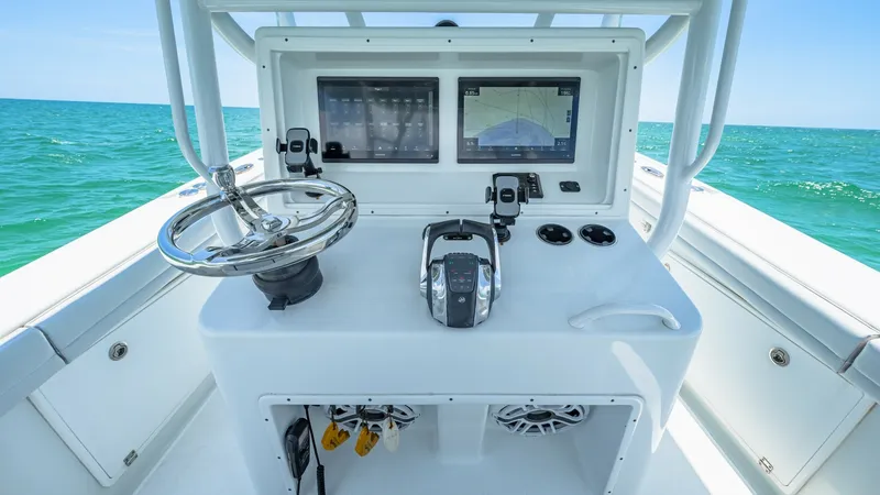 Slide: The Image of Helm Station with Dual Displays This helm station on the 2021 Yellowfin 36 Offshore features dual high-resolution displays for navigation and monitoring, providing the captain with full control and visibility. The stainless steel steering wheel and ergonomic throttle ensure responsive h - 7150891