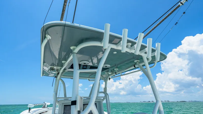 Slide: The Image of T-Top and Rod Holders This image showcases the sturdy T-top of the 2021 Yellowfin 36 Offshore, providing ample shade and protection from the elements. Featuring integrated rod holders, it offers excellent functionality for avid anglers. The sleek design complements the boat's - 7150896