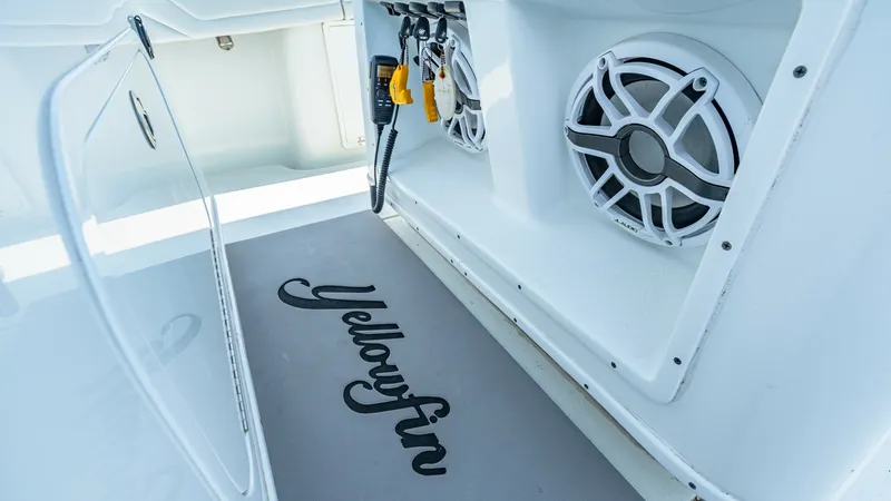 Slide: The Image of Cockpit Storage and Speakers This image showcases the cockpit area of the 2021 Yellowfin 36 Offshore, featuring built-in storage compartments and dual marine speakers. The sleek design highlights the vessel's attention to detail, with high-quality materials and a clean finish. The Ye - 7150895