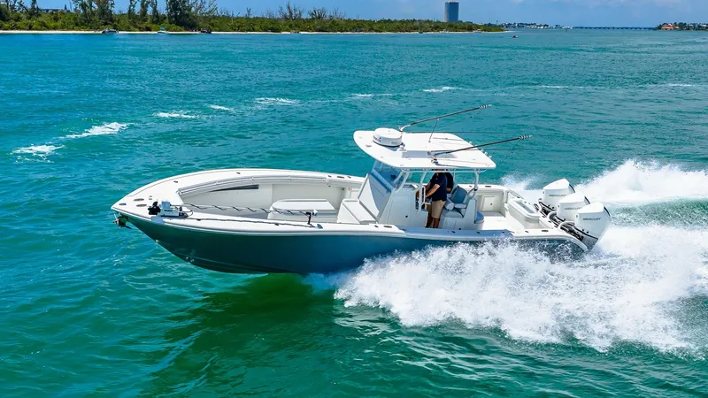 Slide: The Image of Yellowfin 36 Offshore in Action The 2021 Yellowfin 36 Offshore is captured slicing through vibrant blue waters, showcasing its sleek hull and powerful performance. The center console layout is designed for optimal visibility and easy maneuverability, perfect for both fishing and leisure - 7150924