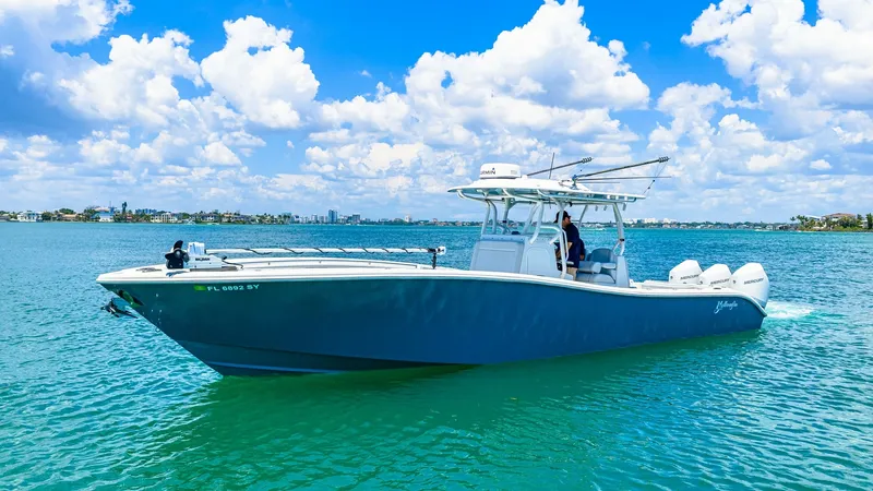 Slide: The Image of Starboard View of Yellowfin 36 Offshore This image showcases the sleek starboard profile of the 2021 Yellowfin 36 Offshore, cutting gracefully through vibrant blue waters. The boat's streamlined hull and spacious deck are ideal for both fishing and leisure, emphasizing its versatility. The T-to - 7150876