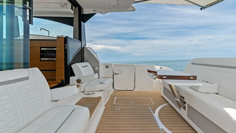 Slide: The Image of Spacious Cockpit with Seating This inviting cockpit of the 2025 Tiara Yachts 48LE offers ample seating with luxurious upholstery, perfect for socializing and relaxation. The teak flooring adds a touch of elegance, while the retractable sunshade provides comfort and protection from the - 7403616