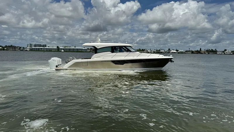 Slide: The Image of Side Profile of Tiara 48LE This image captures the sleek side profile of the 2025 Tiara Yachts 48LE from Galati Yacht Sales. The vessel's modern design is highlighted by its aerodynamic hardtop and elegant hull lines. Outfitted with powerful outboard engines, it promises both perfo - 7179509
