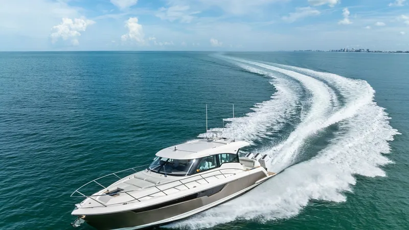 Slide: The Image of Aerial View of Tiara 48LE Cruising The Tiara Yachts 48LE cuts through the open water with sleek elegance, showcasing its powerful performance. The expansive deck and streamlined hull are highlighted against the vibrant ocean backdrop. Designed for luxury and speed, this vessel promises an - 7403673