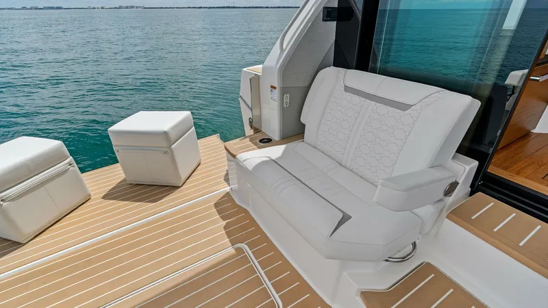 Slide: The Image of Aft Deck Seating Area The aft deck of the 2025 Tiara Yachts 48LE features luxurious seating with plush, weather-resistant upholstery. The elegantly designed space is perfect for relaxing or entertaining, with ample room to enjoy the stunning ocean views. Its sophisticated teak - 7403613