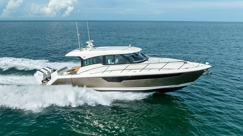 Slide: The Image of Starboard Side View Cruising The 2025 Tiara Yachts 48LE showcases its sleek design and powerful performance as it cuts through the water. The starboard side view highlights the elegant lines and robust outboard engines, offering a glimpse of its speed and agility. With a modern hull - 7403671