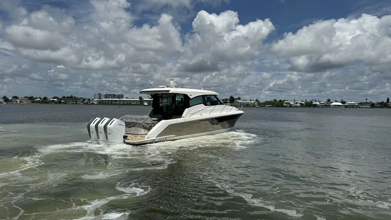 Slide: The Image of Aft View with Triple Engines This image showcases the sleek aft design of the 2025 Tiara Yachts 48LE, featuring powerful triple outboard engines for superior performance. The elegant lines and modern silhouette are highlighted against a scenic water backdrop. Perfect for those seekin - 7179510