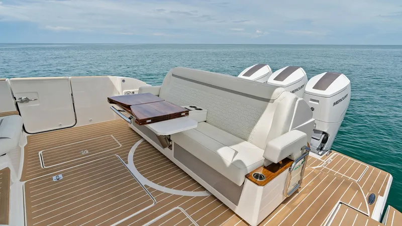 Slide: The Image of Spacious Aft Deck with Seating The aft deck of the 2025 Tiara Yachts 48LE features a comfortable seating area with a sleek foldable table, perfect for outdoor dining or relaxation. The teak flooring adds a touch of elegance and durability, complementing the overall luxurious feel of th - 7403615