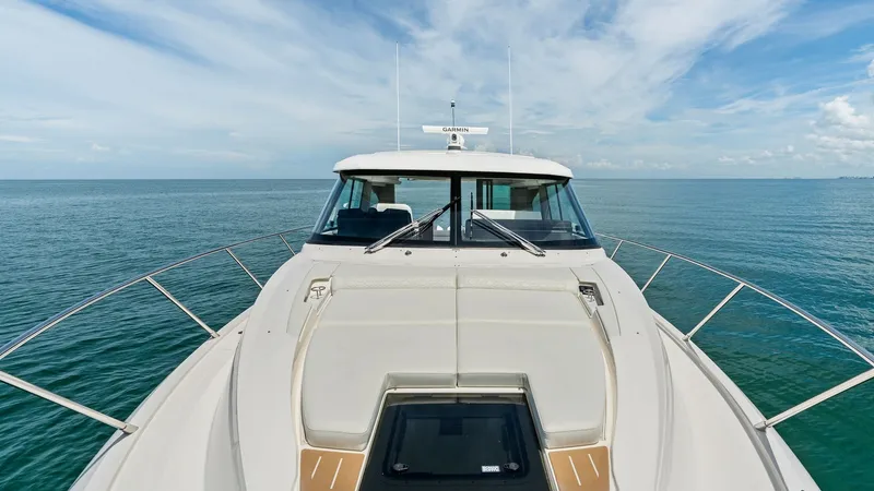 Slide: The Image of Foredeck with Sun Pad and Hatch The foredeck of the 2025 Tiara Yachts 48LE features a spacious and inviting sun pad, perfect for relaxation and enjoying the open sea views. The sleek design includes a central hatch for easy access and ventilation. Stainless steel railings provide safety - 7403621