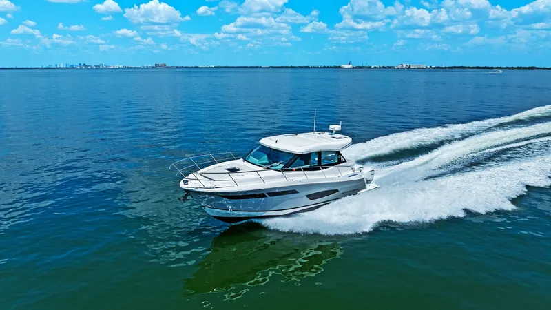 Slide: The Image of Cruising on Open Waters The 2025 Regal 38 EXC is elegantly cruising through open waters, showcasing its sleek design and powerful performance. The vessel's streamlined hull and contemporary styling are complemented by large windows offering panoramic views. Ideal for both leisur - 7180484