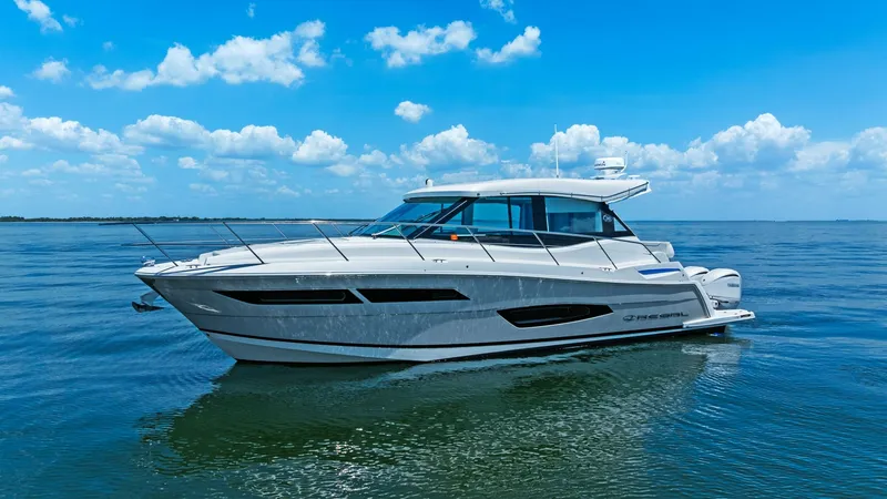 Slide: The Image of Side Profile of Regal 38 EXC This image showcases the sleek side profile of the 2025 Regal 38 EXC by Galati Yacht Sales. The yacht's modern lines and expansive windows highlight its contemporary design, offering panoramic views and abundant natural light. Its aerodynamic shape and gl - 7180473