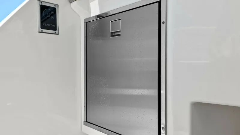 Slide: The Image of Outdoor Galley Stainless Steel Grill This image showcases the sleek stainless steel grill integrated into the outdoor galley of the 2025 Regal 38 EXC. The grill's modern design complements the yacht's luxurious aesthetic, offering a high-quality cooking experience on deck. Perfect for entert - 7180421