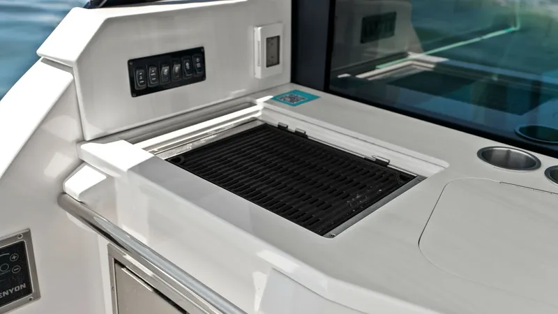 Slide: The Image of Outdoor Galley with Grill This sleek outdoor galley on the 2025 Regal 38 EXC features a built-in grill, perfect for alfresco dining and entertaining. The area is equipped with a control panel for easy operation and a polished countertop that offers ample space for meal preparation - 7180419