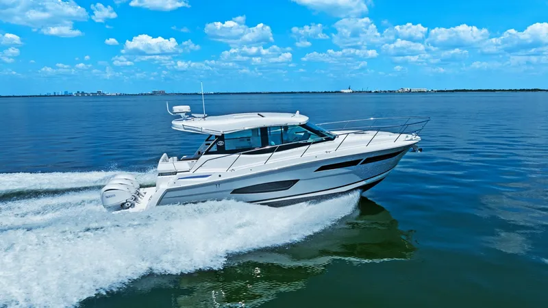 Slide: The Image of Side View Cruising at Speed Experience the thrill of the 2025 Regal 38 EXC as it effortlessly slices through the water, showcasing its sleek design and powerful performance. The aerodynamic lines and modern hull design enhance both speed and fuel efficiency, making it ideal for long - 7180482