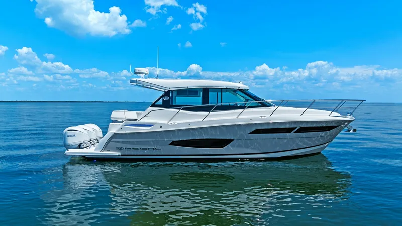The Image of Elegant Starboard Profile View This image showcases the sleek starboard profile of the 2025 Regal 38 EXC. The yacht's contemporary design features a streamlined hull and expansive windows, allowing for stunning panoramic views. Equipped with powerful outboard engines, this vessel promi - 7180411