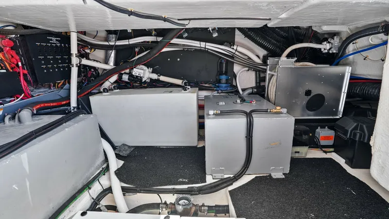 Slide: The Image of Engine Room with Equipment Layout This image showcases the well-organized engine room of the 2025 Regal 38 EXC. The space features neatly arranged components, including the electrical panel and essential mechanical equipment, ensuring efficient operation and easy access for maintenance. T - 7180458