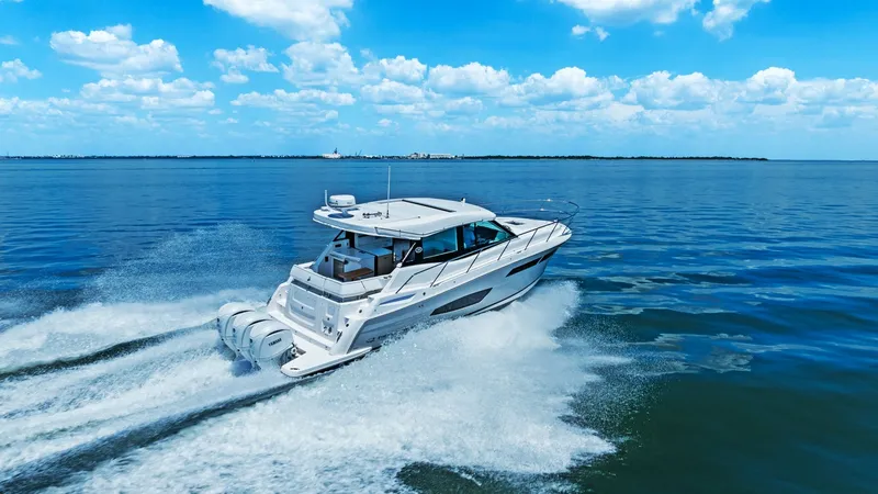 Slide: The Image of Aft View with Triple Engines This image showcases the powerful aft view of the 2025 Regal 38 EXC, featuring triple outboard engines that ensure top-notch performance and speed. The sleek design is complemented by a spacious swim platform, perfect for water activities. The vessel is e - 7180481