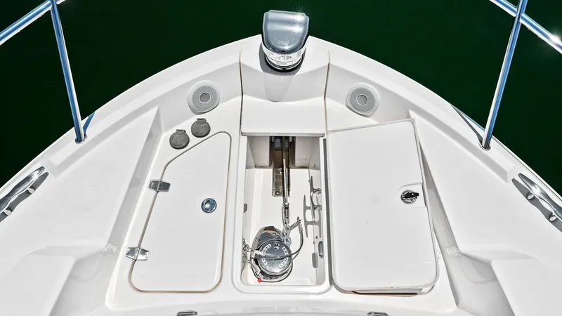 Slide: The Image of Bow Anchor Locker This image showcases the bow anchor locker of the 2025 Regal 38 EXC. The area is designed for easy access with neatly arranged compartments, featuring a robust anchor system and stainless steel fittings. The clean layout and durable materials ensure both - 7180462