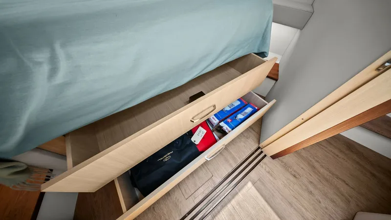 Slide: The Image of Under-Bed Storage Drawers This image showcases the practical under-bed storage drawers in the 2025 Regal 38 EXC, designed for efficient use of space. The drawers are crafted from high-quality wood, providing ample room for personal belongings, ensuring a clutter-free environment. - 7180439