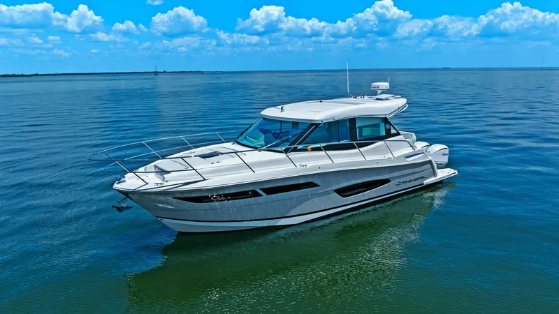 Slide: The Image of Side Profile of Regal 38 EXC This image showcases the sleek side profile of the 2025 Regal 38 EXC, emphasizing its modern design and streamlined hull. The expansive windows provide ample natural light to the interior, while the sturdy rails ensure safety on deck. The yacht's elegant - 7180470
