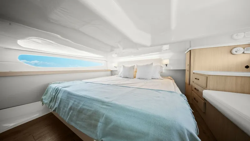 Slide: The Image of Luxurious Forward Stateroom The forward stateroom of the 2025 Regal 38 EXC offers a serene retreat with its spacious layout and elegant design. Featuring a plush double berth, ample natural light through panoramic windows, and stylish wood cabinetry, this space combines comfort and - 7180444