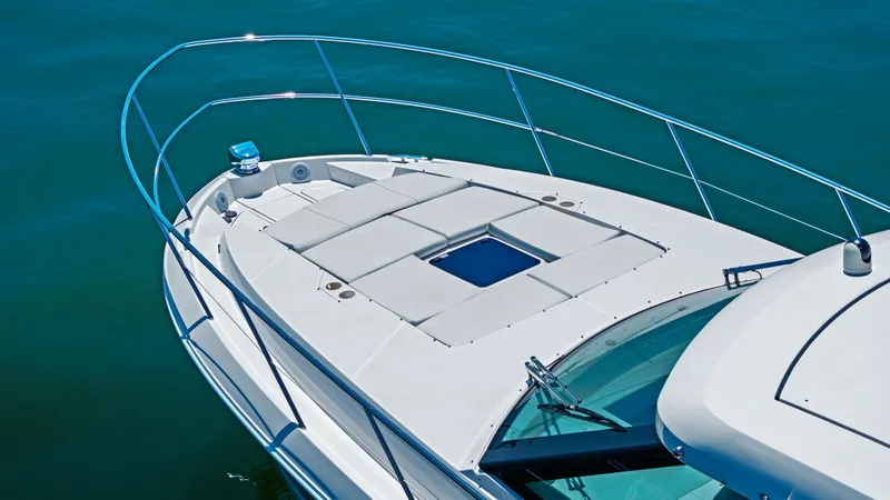 Slide: The Image of Spacious Sunpad on Bow Deck The Regal 38 EXC offers a luxurious sunpad on the bow, perfect for sunbathing and relaxation. Surrounded by sleek stainless steel railings, the area provides safety without compromising the expansive views of the open water. The modern design and high-qua - 7180464